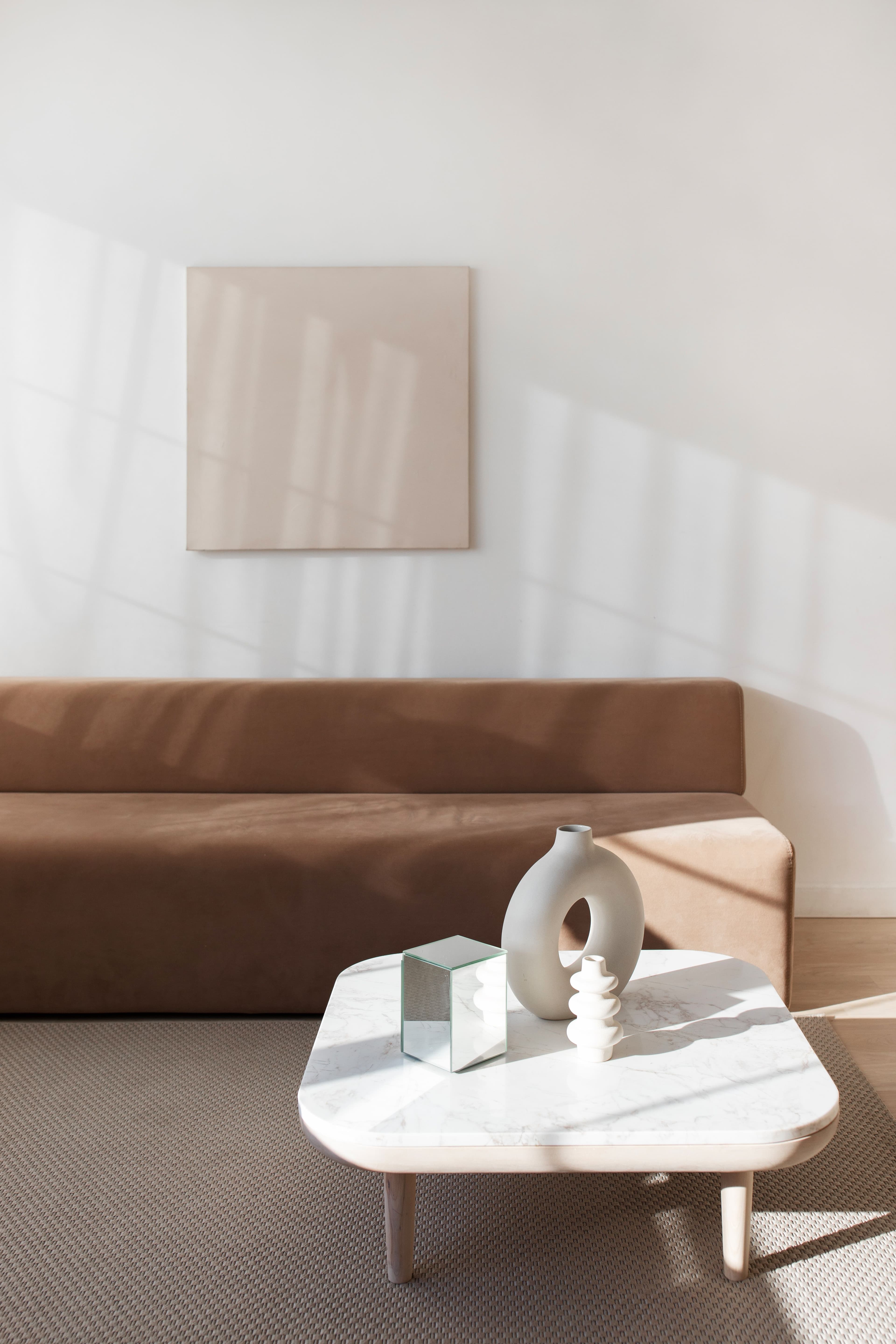 Modern living room with a tobacco sofa and marble coffee table